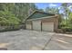 Three-car garage with ample parking space, brick exterior, and green roofing at 120 Tall Pine Dr, Fayetteville, GA 30214