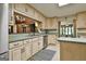 Bright eat-in kitchen featuring light cabinets, sage countertops, and stainless steel dishwasher at 120 Tall Pine Dr, Fayetteville, GA 30214