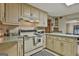 Traditional kitchen with off-white cabinetry, vintage-style range and sage countertops at 120 Tall Pine Dr, Fayetteville, GA 30214