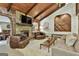 Cozy living room with vaulted wood ceilings, a stone fireplace, and views to adjoining rooms at 120 Tall Pine Dr, Fayetteville, GA 30214