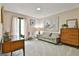 Bright living room featuring a cozy sofa, stylish decor, and a window offering natural light at 120 Tall Pine Dr, Fayetteville, GA 30214
