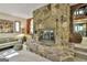 Cozy living room featuring stone fireplace, plush seating, and elegant decor at 120 Tall Pine Dr, Fayetteville, GA 30214