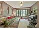 Inviting living room with large bay window, vintage piano, and comfortable green velvet sofa at 120 Tall Pine Dr, Fayetteville, GA 30214