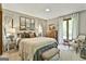 Bright main bedroom with a large bed, windows, and a comfortable seating area at 120 Tall Pine Dr, Fayetteville, GA 30214