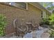 Back patio with stone flooring, brick walls, and wicker furniture at 120 Tall Pine Dr, Fayetteville, GA 30214