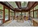 Bright sunroom with wood ceiling, brick walls, large windows, and skylights offering natural light and a tranquil space at 120 Tall Pine Dr, Fayetteville, GA 30214