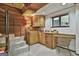 Convenient wet bar area complete with wood cabinetry, sink, desk, and a window with outdoor views at 120 Tall Pine Dr, Fayetteville, GA 30214