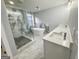 Bright bathroom with a glass shower, a standalone tub, and double sinks at 3189 Jackson, Hapeville, GA 30354