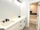 Modern bathroom features a dual sink vanity with black fixtures and a tiled shower and bathtub at 3189 Jackson, Hapeville, GA 30354