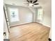 Bright bedroom with hardwood floors and natural light from two large windows and a ceiling fan at 3189 Jackson, Hapeville, GA 30354