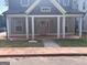 Charming new two-story home featuring a welcoming front porch and a pink front door at 3189 Jackson, Hapeville, GA 30354