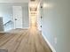 A light-filled hallway with wood floors leads to various rooms at 3189 Jackson, Hapeville, GA 30354