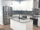 Modern kitchen featuring white cabinets, stainless steel appliances, granite counters, and a gray tile backsplash at 3189 Jackson, Hapeville, GA 30354
