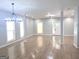Spacious living room area with light gray walls, tile floors, a modern chandelier, and multiple windows at 3189 Jackson, Hapeville, GA 30354