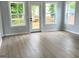 Well-lit living room with big windows, door to outside deck and wood-look flooring at 3189 Jackson, Hapeville, GA 30354