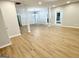Open-concept living space with light wood floors, bright windows, and contemporary lighting at 3189 Jackson, Hapeville, GA 30354