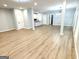 Spacious open-concept living area with wood-look floors, leading into dining and kitchen spaces at 3189 Jackson, Hapeville, GA 30354