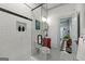 Bathroom showcasing a glass-enclosed shower, shiplap walls, and a vintage cabinet at 7550 Fielder Rd, Jonesboro, GA 30236