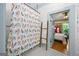 Bright bathroom featuring a bird-themed shower curtain and a decorative wooden ladder at 7550 Fielder Rd, Jonesboro, GA 30236