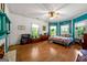 Bright bedroom featuring hardwood floors, white shiplap walls and a decorative ceiling fan at 7550 Fielder Rd, Jonesboro, GA 30236