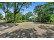 Gravel driveway leading to a picturesque blue home with a covered porch at 7550 Fielder Rd, Jonesboro, GA 30236