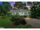 Charming blue home with a covered porch, lush landscaping, and a welcoming gravel driveway at 7550 Fielder Rd, Jonesboro, GA 30236