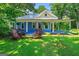 Charming blue home with a covered porch framed by white columns at 7550 Fielder Rd, Jonesboro, GA 30236