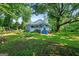 Charming two-story blue home with a welcoming front porch and lush green yard at 7550 Fielder Rd, Jonesboro, GA 30236