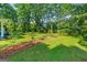 Well-maintained front yard with mature trees and landscaping, creating a welcoming and picturesque setting for the home at 7550 Fielder Rd, Jonesboro, GA 30236