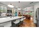 Kitchen island with seating and stainless steel appliances with view to the dining room at 7550 Fielder Rd, Jonesboro, GA 30236
