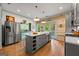 Bright kitchen with stainless steel appliances, gray island, and rustic wood accents at 7550 Fielder Rd, Jonesboro, GA 30236