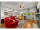 Bright living room featuring hardwood floors, a cozy red sofa and barn door feature at 7550 Fielder Rd, Jonesboro, GA 30236