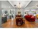 Open-concept living and dining area with hardwood floors and barn door feature at 7550 Fielder Rd, Jonesboro, GA 30236