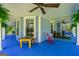 Inviting covered porch with seating area featuring fans and views of the surrounding greenery at 7550 Fielder Rd, Jonesboro, GA 30236