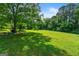 Lush green yard with mature trees, offering ample space for outdoor activities at 7550 Fielder Rd, Jonesboro, GA 30236