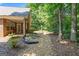 Lush backyard featuring manicured landscaping, a covered patio, and mature trees at 1152 Strath Clyde Way, Mcdonough, GA 30253