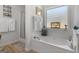 Bright and spacious bathroom featuring a soaking tub, walk-in shower, and frosted window for privacy at 1152 Strath Clyde Way, Mcdonough, GA 30253