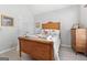 Comfortable bedroom showcasing a classic wooden bed frame, complemented by soft decor and ample closet space at 1152 Strath Clyde Way, Mcdonough, GA 30253