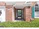 Inviting front entrance with brick facade, elegant glass door, and well-maintained landscaping provides great curb appeal at 1152 Strath Clyde Way, Mcdonough, GA 30253