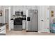 Updated kitchen with stainless steel appliances, sleek black countertops, and ample storage space at 1152 Strath Clyde Way, Mcdonough, GA 30253