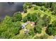 Expansive aerial view showcasing a lakeside property with lush greenery and waterfront access at 312 Flat Shoals Church Rd, Stockbridge, GA 30281