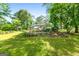 Charming home with a spacious backyard, stone terrace, and mature trees at 312 Flat Shoals Church Rd, Stockbridge, GA 30281