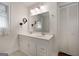 Bright bathroom with a double sink vanity, white cabinetry, large mirror, and neutral tile floors at 312 Flat Shoals Church Rd, Stockbridge, GA 30281