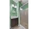 Bathroom featuring green textured walls, white shower and dark-stained vanity at 312 Flat Shoals Church Rd, Stockbridge, GA 30281