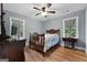 Bedroom featuring light gray walls, wood floors, neutral curtains, and an antique sewing machine at 312 Flat Shoals Church Rd, Stockbridge, GA 30281