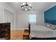 Stylish bedroom featuring hardwood floors, modern lighting, blue accent wall and a sliding closet door at 312 Flat Shoals Church Rd, Stockbridge, GA 30281