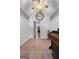 Open entrance foyer with white wainscoting walls, tile floor, piano and view to living area at 312 Flat Shoals Church Rd, Stockbridge, GA 30281