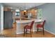 Open kitchen with bar seating, hardwood floors, and stainless steel appliances at 312 Flat Shoals Church Rd, Stockbridge, GA 30281