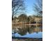 Scenic lake view with calm waters, surrounding trees, and a private dock for relaxing enjoyment at 312 Flat Shoals Church Rd, Stockbridge, GA 30281