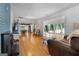 Spacious living room with hardwood floors and a brick fireplace, showcasing an open floor plan at 312 Flat Shoals Church Rd, Stockbridge, GA 30281